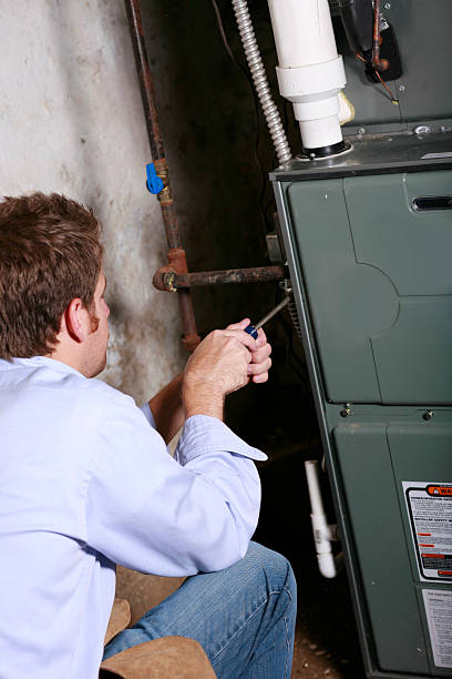 A service man working on a home furnace