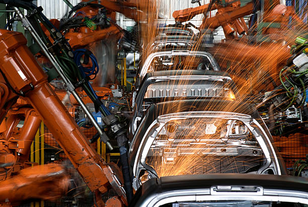 Robots In a Car Factory Robots Working In Car Industry car plant photos stock pictures, royalty-free photos & images