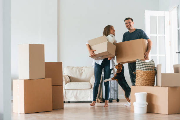 istock Holding boxes. Young couple moving to new home 1822184955