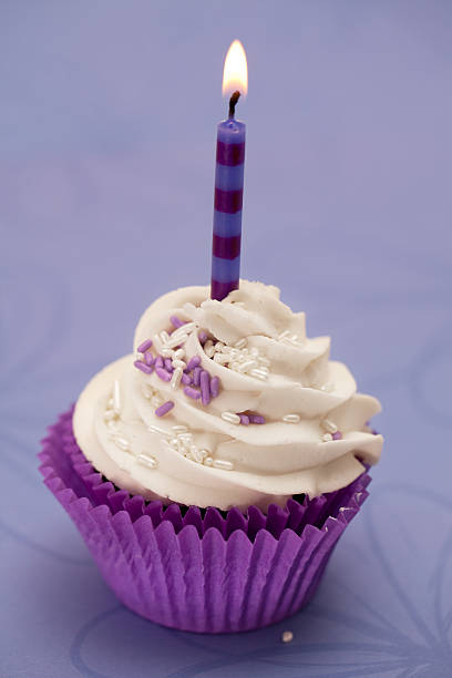 Purple birthday cupcake stock photo