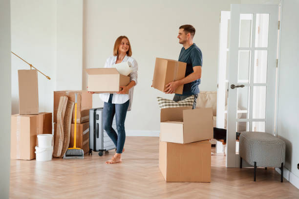 istock Holding boxes. Young couple moving to new home 1822186577