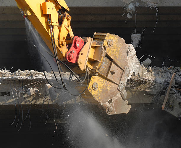 istock stockphoto building demolish old digger water jet 182218848