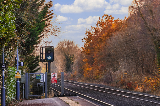 November 30th. 2023. A view of Lapworth Solihull West Midlands England UK. Diesel powered railway line in the English countryside. Station on a bright day in late summer. Green light on track.