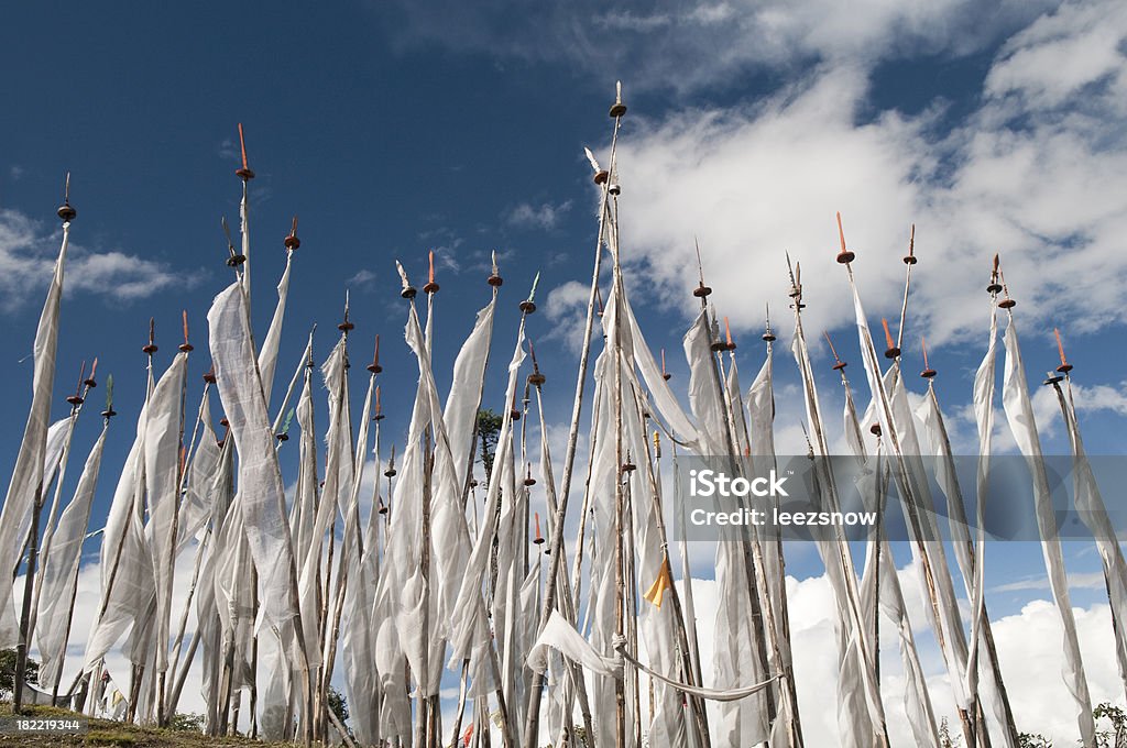 Prayer Flags against the Sky Looking up at a hillside filled with traditional Bhutanese white prayer flags topped with daggers.See a lightbox of all my Bhutan images: Asia Stock Photo