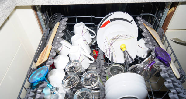 istock Dishwasher with freshly washed plates, glasses and cutlery 1822212610