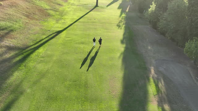 Aerial view of a golfer with caddy on the golf course