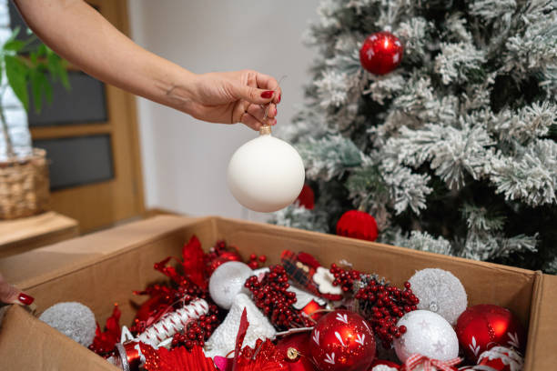 istock Unrecognizable woman decorating a Christmas tree with white ornament 1822215514