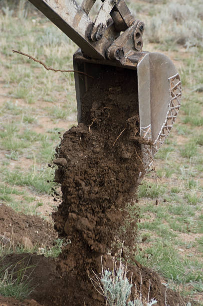 istock Trackscavator Bucket Dumping Dirt 182221565