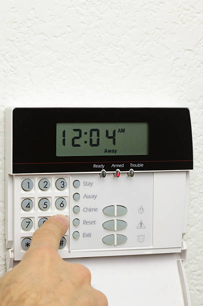 istock Man disarming a home alarm (vert) 182221601