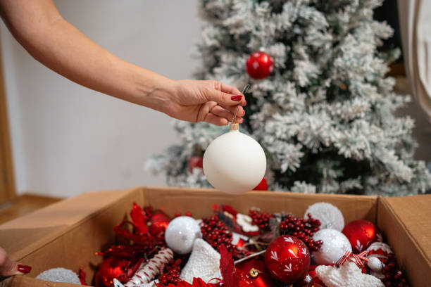 istock Unrecognizable woman decorating a Christmas tree with white ornament 1822217113