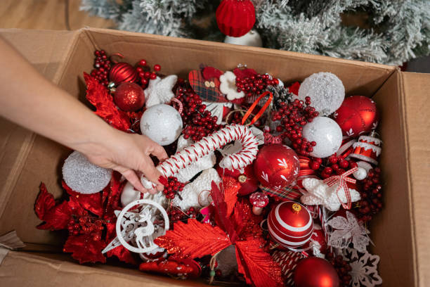 istock Unrecognizable woman decorating a Christmas tree with candy cane ornament 1822217131