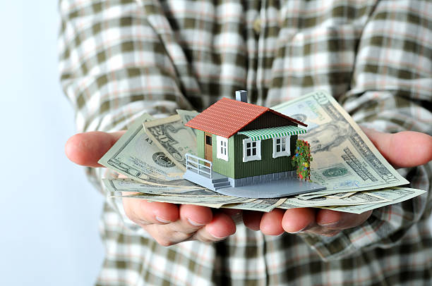 istock man holding a small house in his hands 182222937