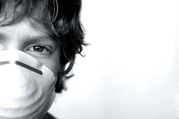 istock Boy with Flu Virus Wearing Mask 182222998