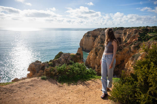 istock Young woman walks up trail, on coastal cliffs 1822236489
