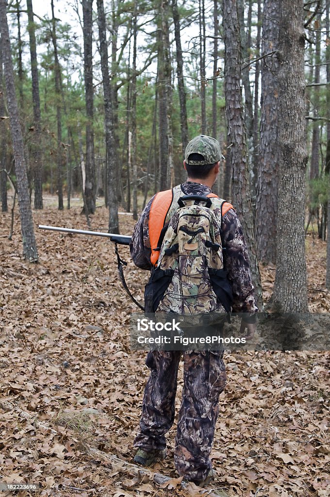 Hunter with Rifle Male dressed in camoflauge in the forest Backpack Stock Photo