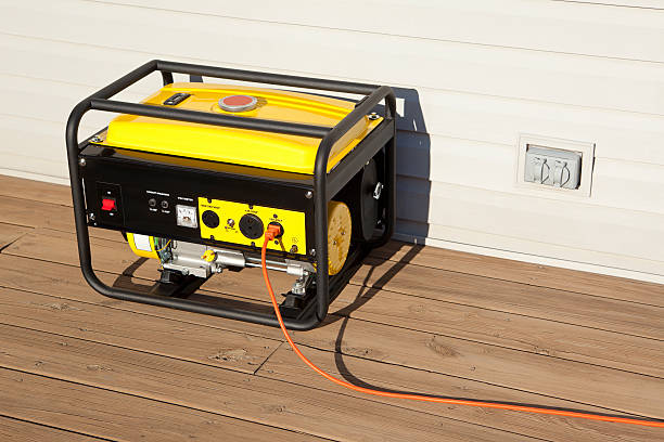 Portable Electric Generator "Extension cord plugged into a gasoline powered, 4000 watt, portable electric generator.Please also see;" portability stock pictures, royalty-free photos & images