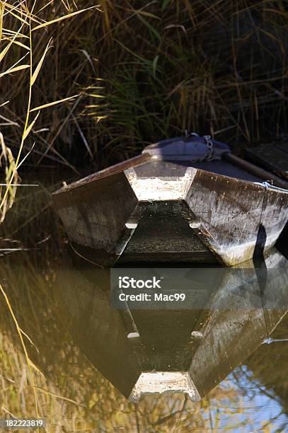 Lonely Boat With Reflection Of Sky Stock Photo - Download Image Now - Backwater, Blue, Color Image