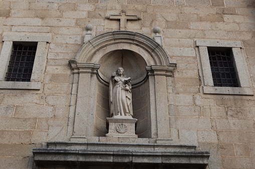 Venice, Italy - October 10th 2022:  Old marble statue of the virgin Mary with the Jesus child over a doorway in the center of the old and famous Italian city Venice