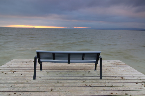 Bench on  Jetty with dramatic stormy sky