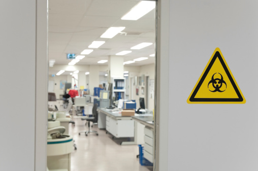 A yellow biohazard sign is marking the entrance to the microbiology laboratory