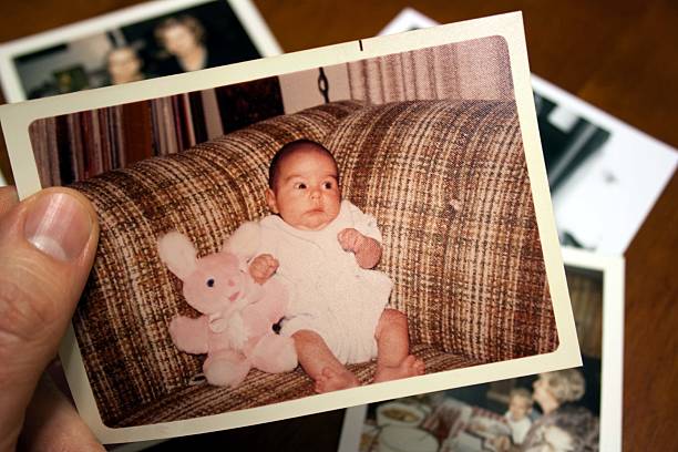 Vintage photo of baby and stuffed toy rabbit stock photo