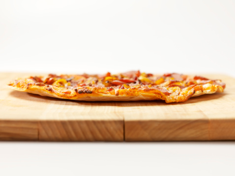 Pepperoni and Roasted Peppers Pizza on a cutting Board - Photographed on a Hasselblad H3D11-39 megapixel Camera System