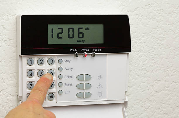 istock Woman disarming a home alarm 182225809