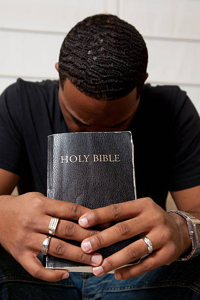 istock Man Praying with his Bible 182225834