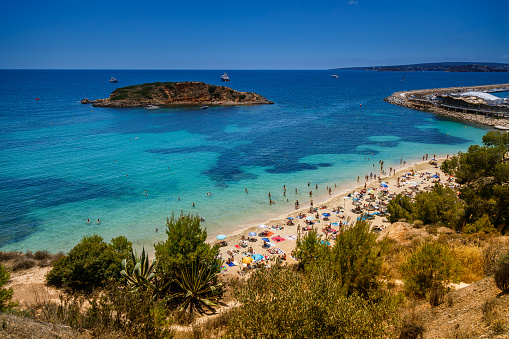 A popular Portals Nous (Playa Oratorio) beach in Mallorca with crowds of people