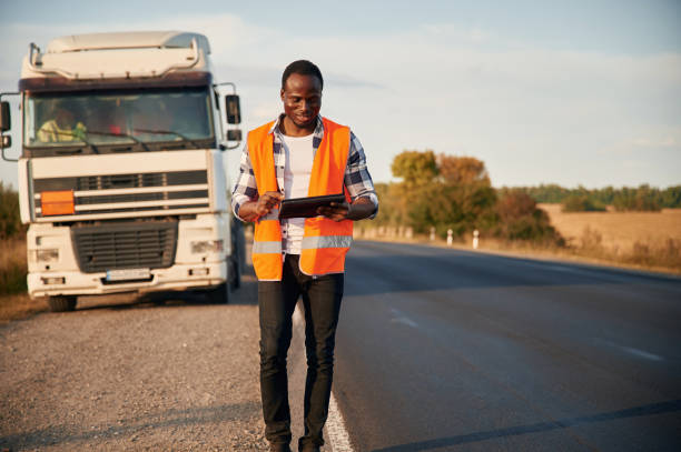 istock Front view. Black man is standing on the road with truck on it 1822269245
