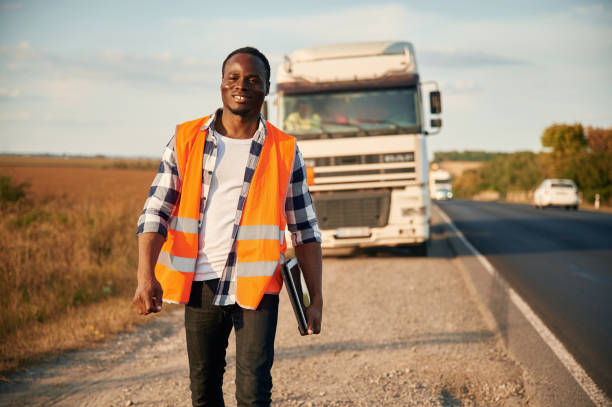 istock Front view. Black man is standing on the road with truck on it 1822269257