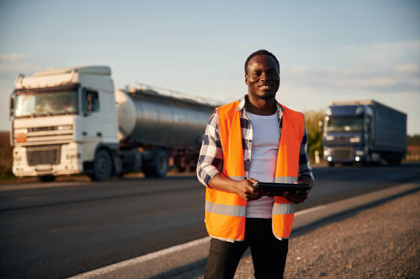 istock Two vehicles behind him. Black man is standing on the road 1822269796