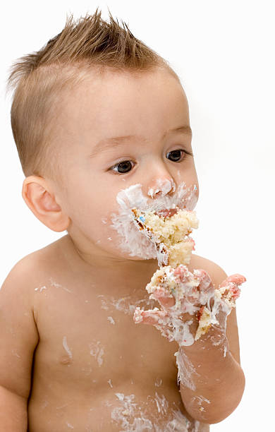 istock Baby eating birthday cake 182227014