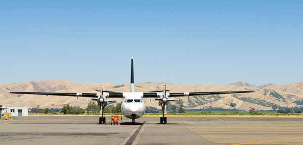 A large propeller aeroplane (a Fokker F-27-500C Friendship) on the tarmac at Blenheim Airport, on New Zealand's South Island.