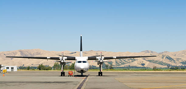 Large Propeller Plane on Airport Tarmac A large propeller aeroplane (a Fokker F-27-500C Friendship) on the tarmac at Blenheim Airport, on New Zealand's South Island. panorarma stock pictures, royalty-free photos & images