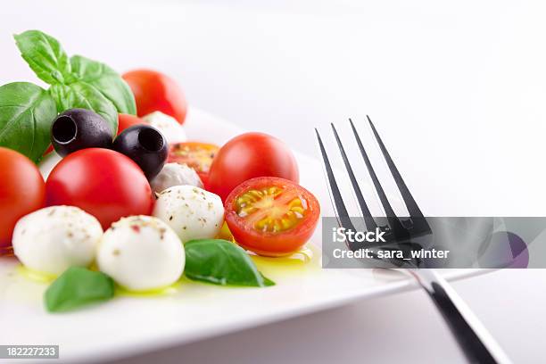 Fresh Caprese Salad On A Table In Bright Light Stock Photo - Download Image Now - Caprese Salad, Appetizer, Basil