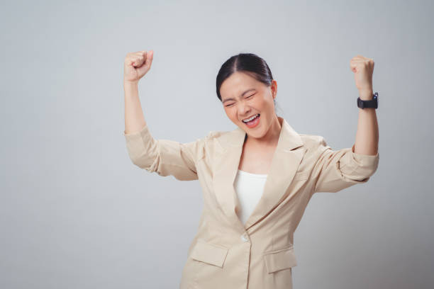 istock Asian woman happy confident make a winning gesture standing isolated on white background. 1822280434