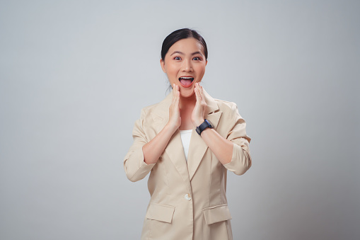 Asian woman happy smiling excited with empty copy space for advertising and looking at camera isolated on white background.