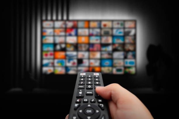 istock Man watching TV with remote control in hand. 1822285300