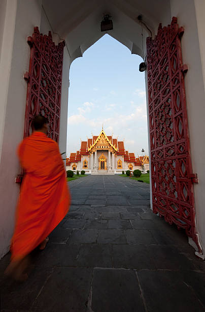 istock Buddhist monk walking into the Marble Temple (Wat Benchamabophit), Bangkok. 182228741