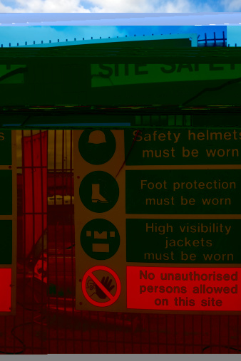 Instructions on site safety fastened to the fence of a coastal construction site.