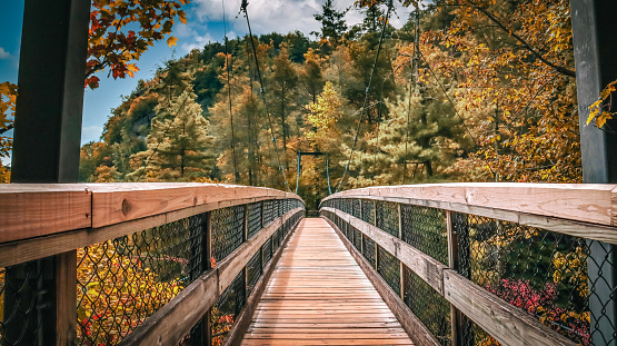 An autumn look at the suspension bridge located at Tallulah Gorge State Park in Tallulah Falls, Georgia.