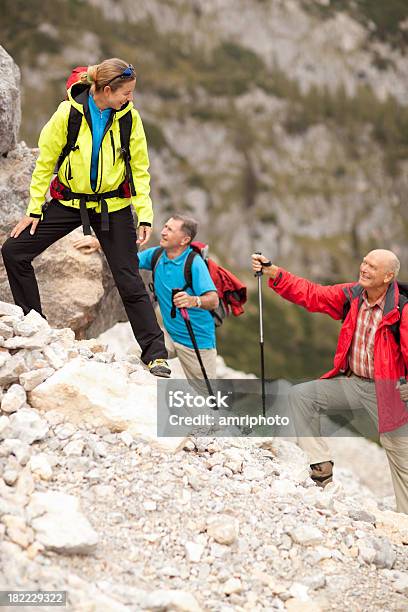 Feliz Mujer Con Mayor Hikers Guía De Excursionismo Foto de stock y más banco de imágenes de Aire libre - Aire libre, Excursionismo, Moda