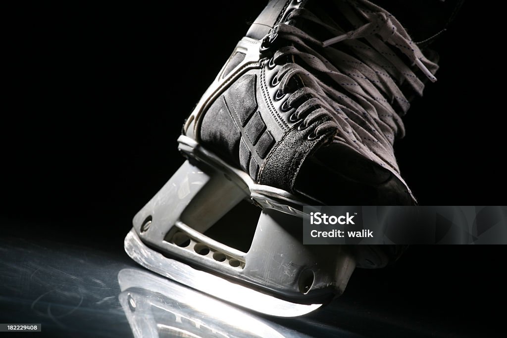 Close-up of a skate with sharp blade over shiny ice More hockey shots - check my lightbox. Ice Skate Stock Photo