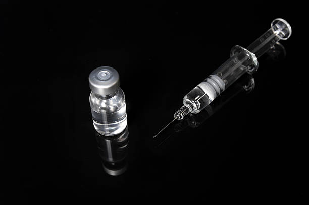 Syringe and Vial on Gloss Black stock photo