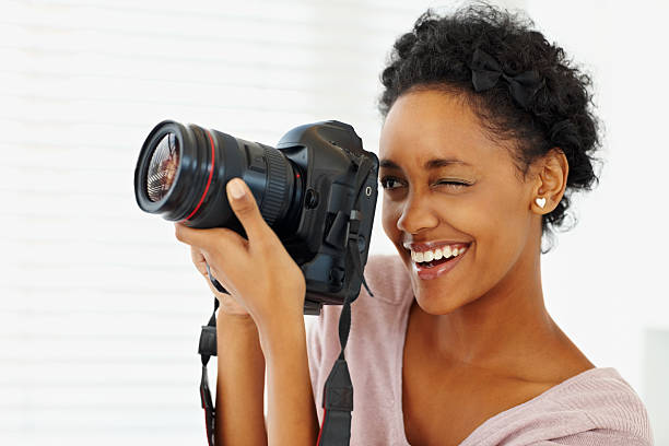 istock Smiling photographer clicking with a digicam 182230547