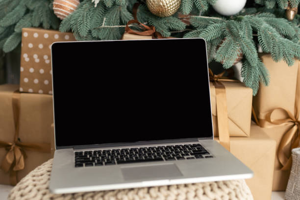 istock laptop and Christmas tree in the background 1822306869