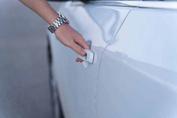 The hand that opens the car door.
