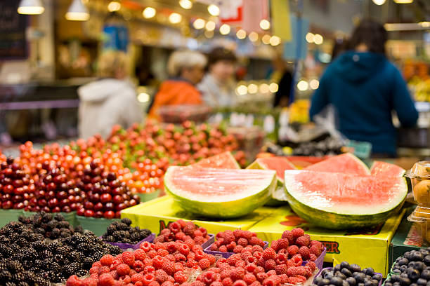 Vancouver, Canada, Granville Island Market Fruit stand at the Granville Island Market in Vancouver(shallow depth of field) granville island stock pictures, royalty-free photos & images