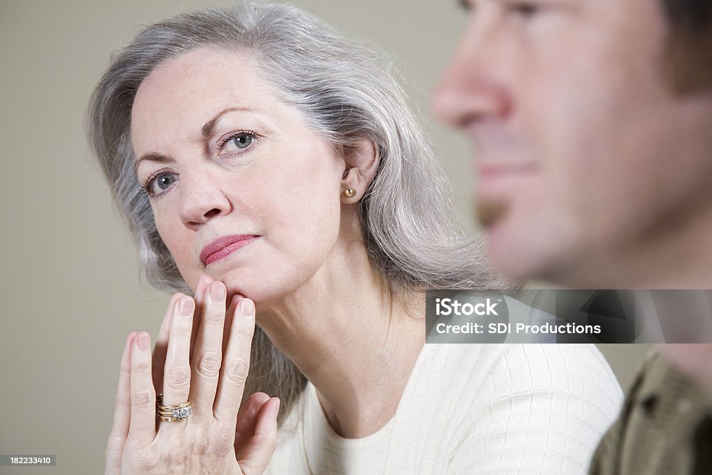 Serious CEO in a meeting, with hands to her chin "Serious CEO in a meeting, with hands to her chin.See more from this series:" 60-69 Years Stock Photo